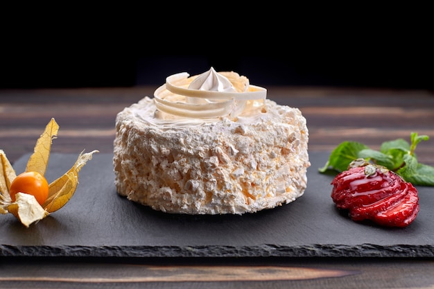 Dessert Raffaello, on a dark background. Stone, wooden board.