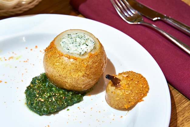 Dessert of stewed pears with cottage cheese filling on table