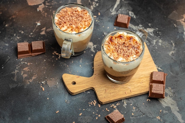 Dessert three chocolate in a glass jar on a wooden board Food recipe background Close up