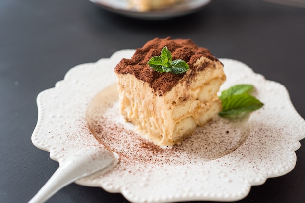 dessert tiramisu cake decorated mint on black background