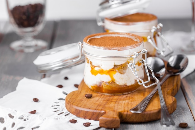 Dessert tiramisu in a jar with sea-buckthorn puree