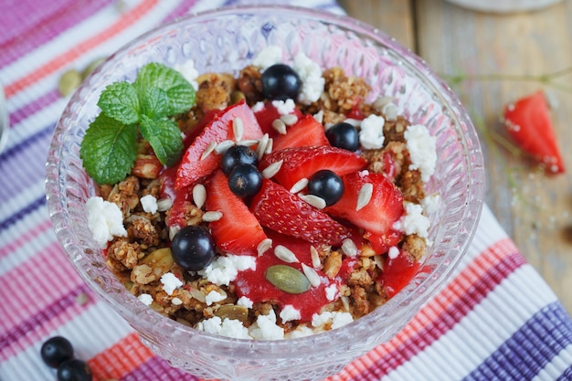 Dessert with fresh berries, cottage  cheese, granola and berries jam.