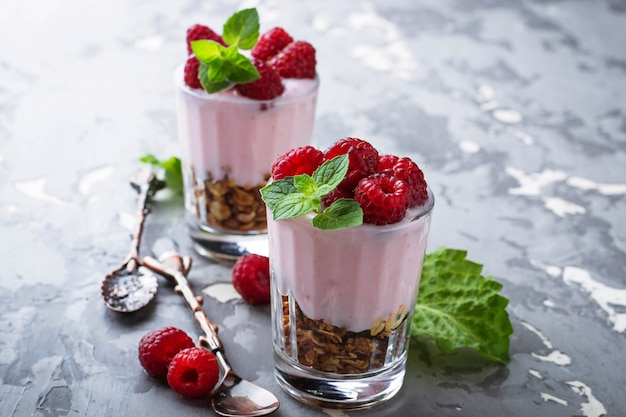 Dessert with granola, yogurt and raspberry. Selective focus