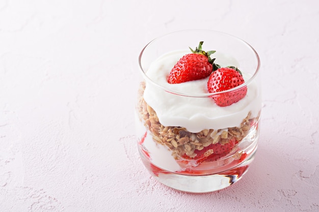 Dessert with whipped cream, granola and strawberries