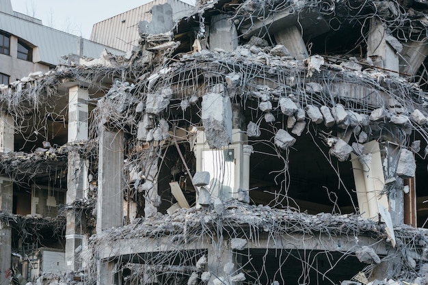 Photo destroyed building protruding reinforcement demolition of a building house ruins reconstruction