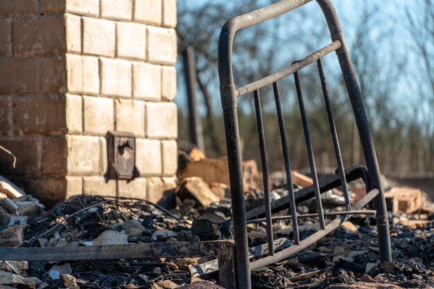 Destroyed houses as a result of a fire in russia bricks and\
parts of walls various household items broken windows covered with\
ash lie on the surface of the earth natural disaster