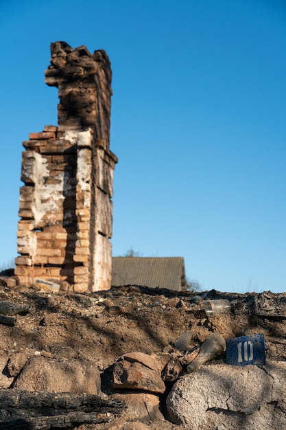 Разрушенные дома в результате пожара в России Кирпичи и части стен различные предметы быта разбитые окна покрытые пеплом лежат на поверхности земли Стихийное бедствие