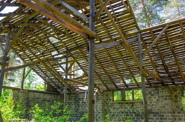 The destroyed wooden roof of a large hangar.