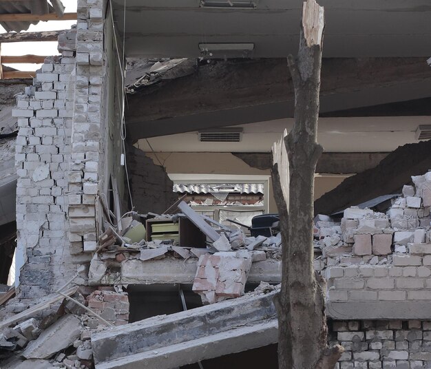 Photo the destruction of a public building after a rocket attack is depicted