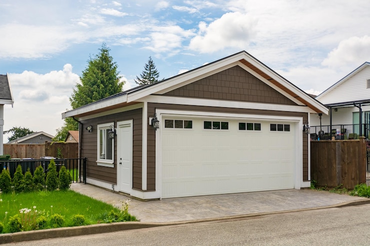 Detached garage of residential house with asphalt road in front