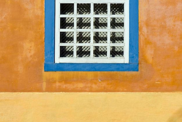 Detail of ancient window in yellow wall