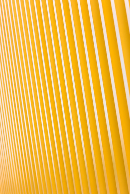 Detail of bright yellow metal building facade. For background