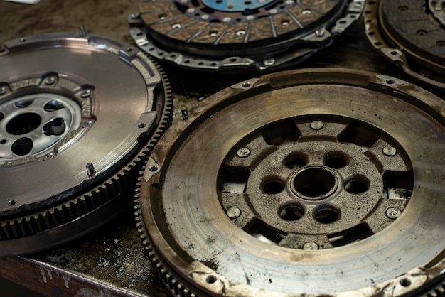 Detail of Car flywheel in a workshop, car spare parts old and new