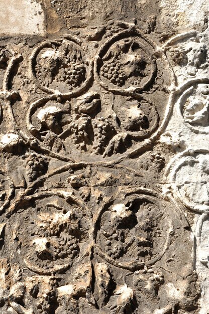 Photo detail of carved stone with grape