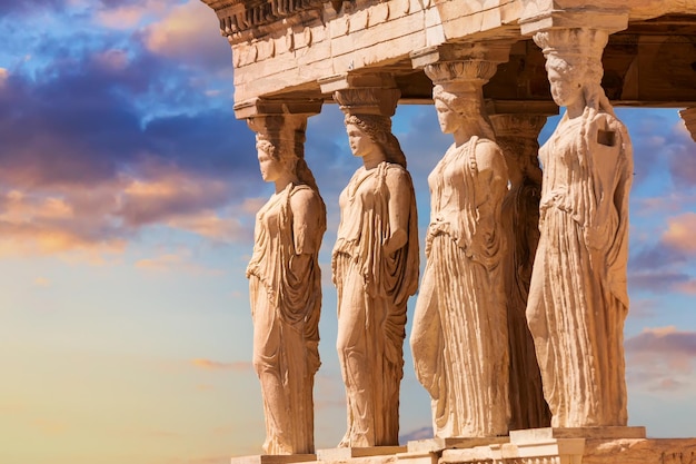 Detail of Caryatid Porch on the Acropolis uring colorful sunset in Athens Greece Ancient Erechtheion or Erechtheum temple World famous landmark at the Acropolis Hill