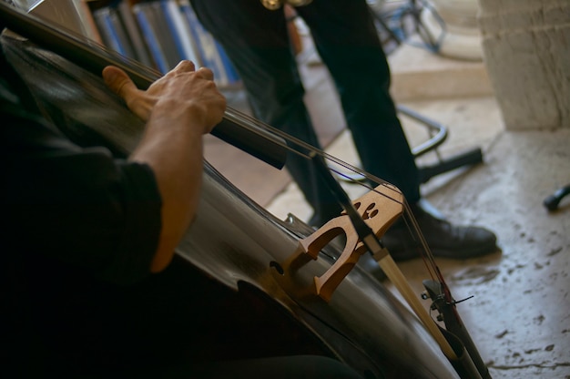 Detail of a cello while being played during a live jazz concert.