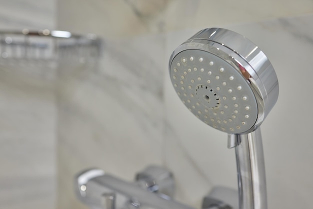 Detail of a corner shower cabin with wall mount shower attachment