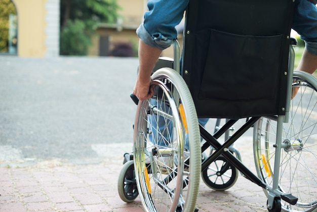 Detail of a disabled man trying to getting on a ramp