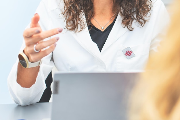 Detail of a female doctor listening to patient