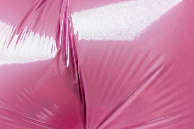 Detail of the folds of a helium pink balloon from foil