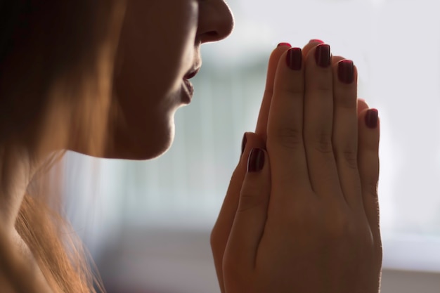 Detail of girl praying.