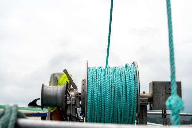 Detail of a green rope on a fishing boat