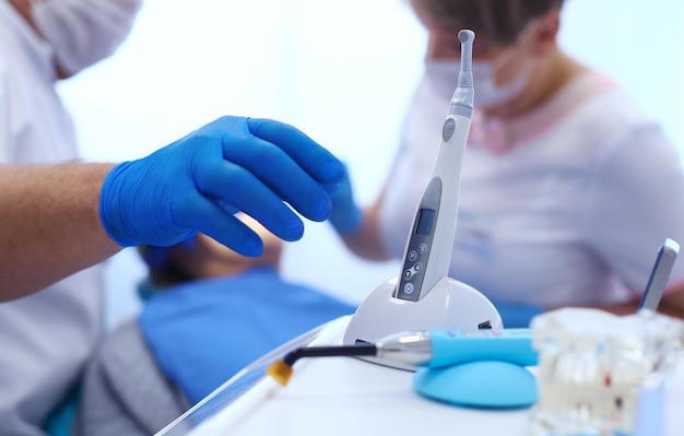 Detail of hand holding dental tools in dental clinic Dentist Concept