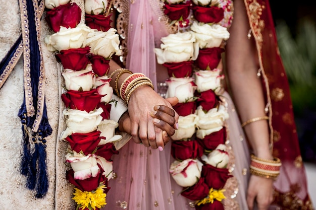 Photo detail of hands and clothing during indian wedding ceremony