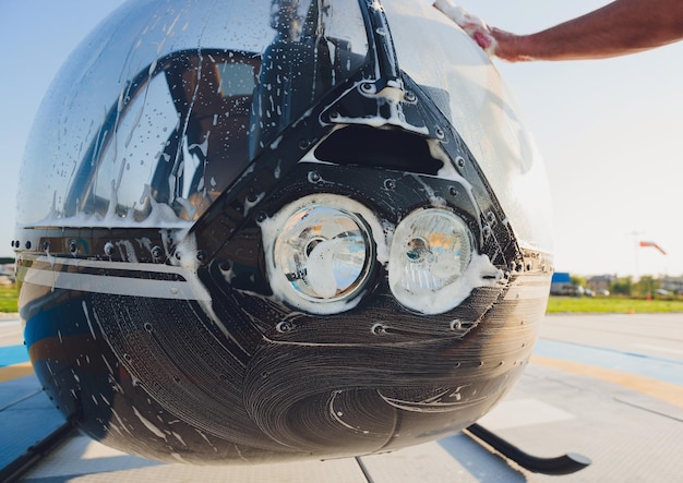 Detail of Helicopter Engineering on a beautiful blue skyMilitary Helicopter fighter cockpit Outdoor wash with sponge and foam