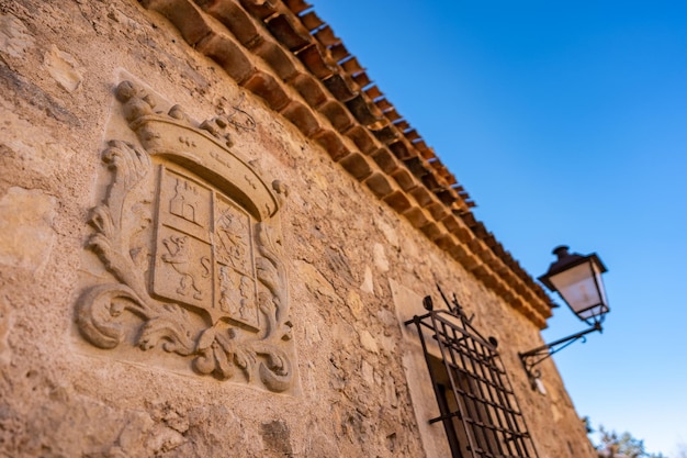 Detail of heraldic shield on the walls of the houses of the medieval village of Pedraza in Segovia