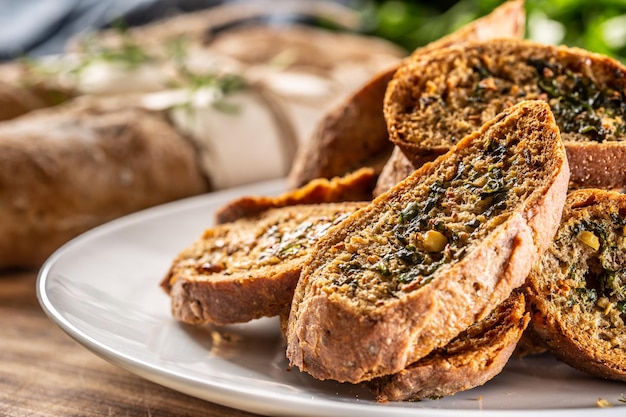 Detail of herb and garlic bread slices placed on a plate for serving