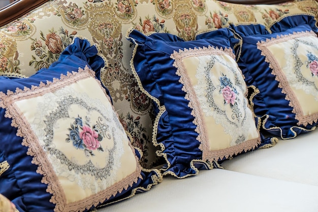 Detail image of pillows on an antique luxury sofa