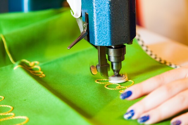 Detail of a lady hand at sewing machine