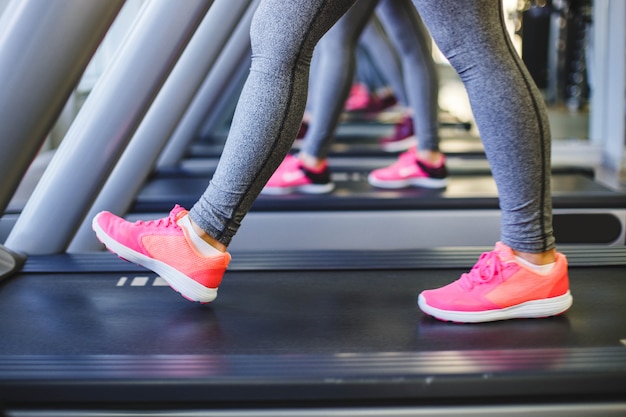 Detail of legs of women running on treadmills