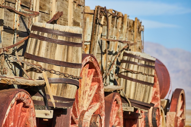 Detail of old train cart with wheels and barrels