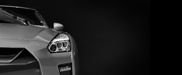 Foto detail op een van de led-koplampen moderne auto op zwarte muur, vrije ruimte aan de rechterkant voor tekst.