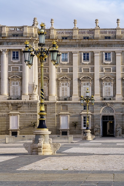 Detail of the outer courtyard of the royal palace of Madrid, with lampposts, arches and neoclassical style. Spain.