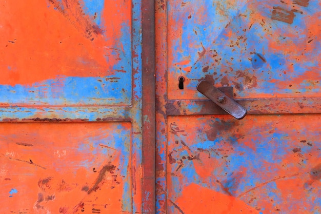 Detail of peeling off colourful iron gate