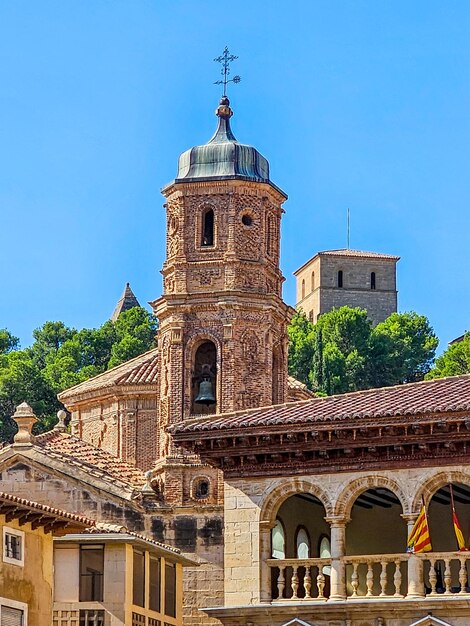 Detail of the Piarist tower and the background of the Calatravos castle in Alcaniz