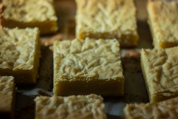 Photo detail of a piece of a delicious white chocolate brownie straight out of the oven