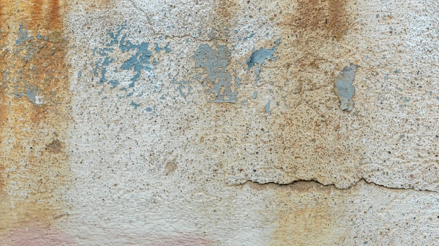 Detail of a portion of the wall. Tears, hiding, paint, concrete.