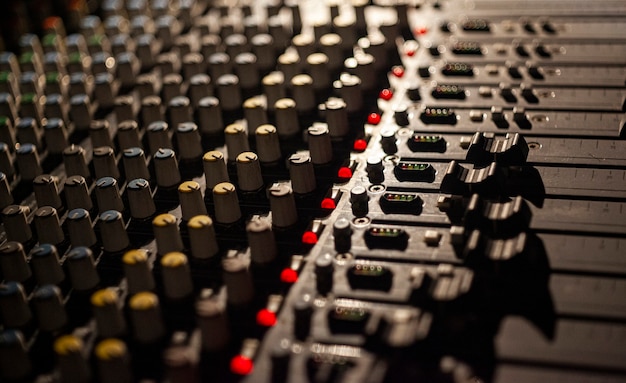 Detail of potentiometers and controls of a multichannel audio mixer used to manage a concert