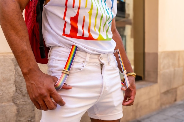 Detail of the rainbow suspenders of a gay black man at the pride party LGBT flag