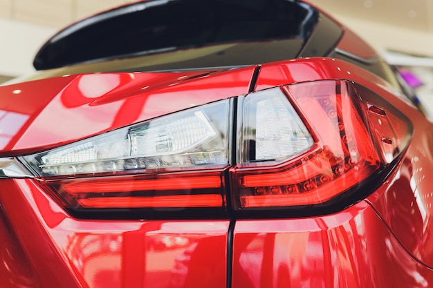 Detail on the rear light of a red car.