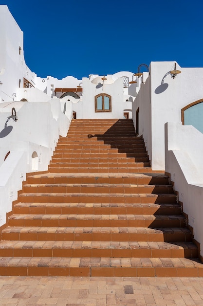 Detail of stairs and white wall of a house on the street of Egypt in Sharm El Sheikh, architecture concept