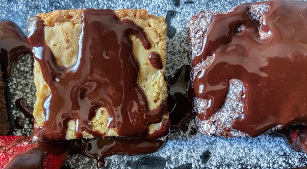 Photo detail of two delicious piece of dark and white chocolate brownie on a plate