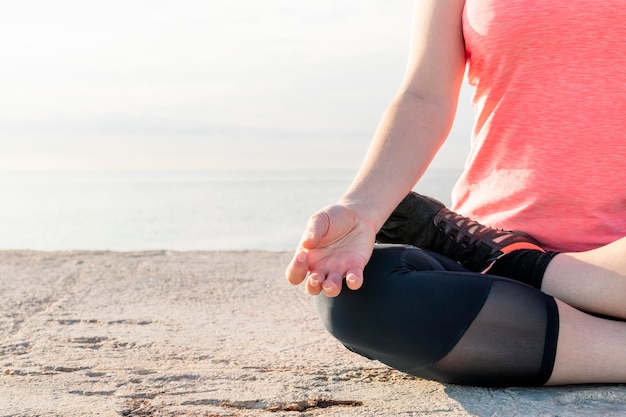 Detail of unrecognizable woman in lotus position