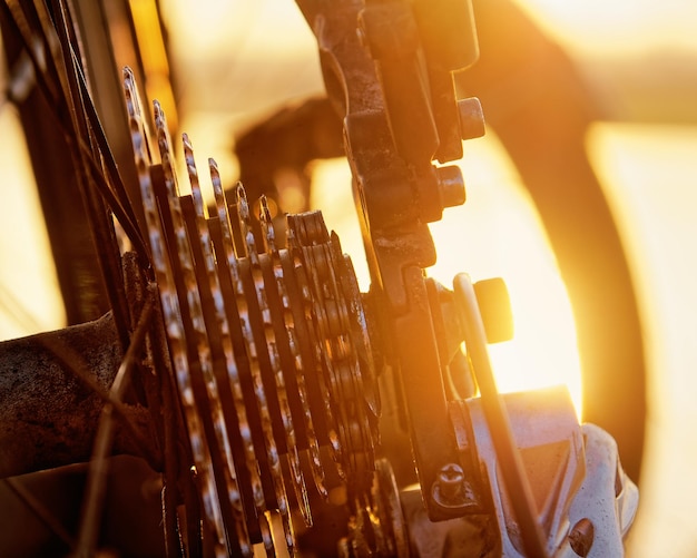 Detail view of a bicycle in a backlit situation close up on chain and gears