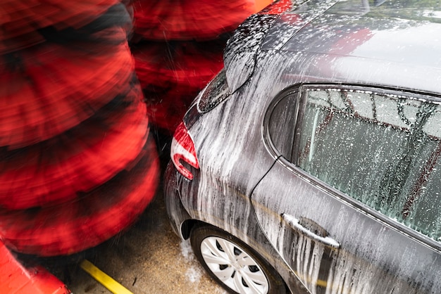 Detail view on car wash, car wash foam water, Automatic car wash in action