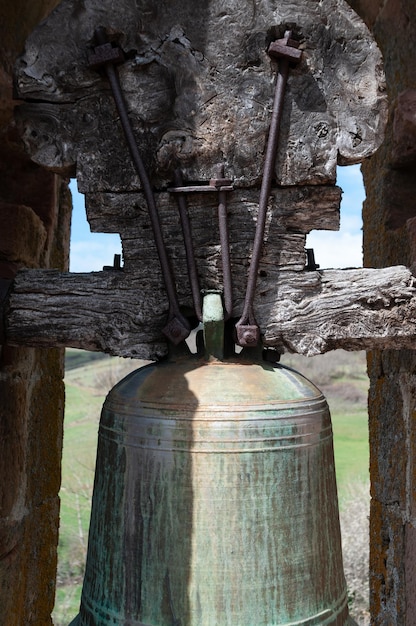 Detail view of an old bell and its yoke in a Spanish town